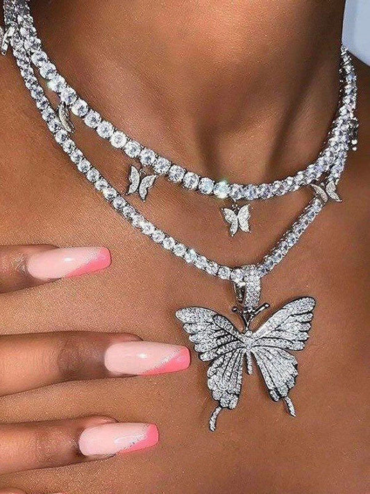 Haut court asymétrique tendance à col licou avec papillon et strass
